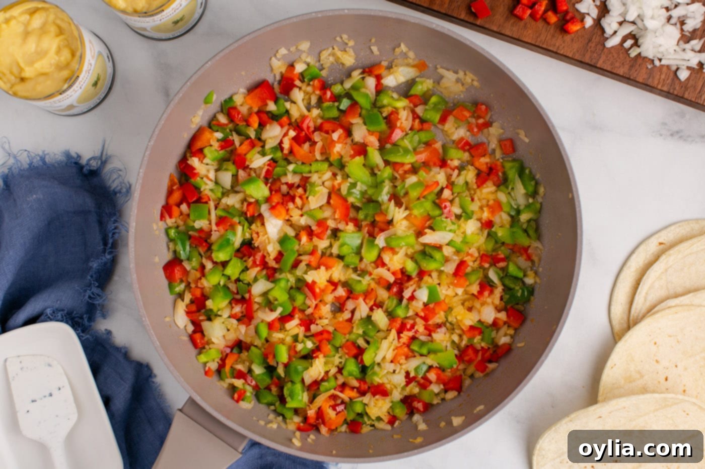 sauteed bell peppers and onion in a skillet