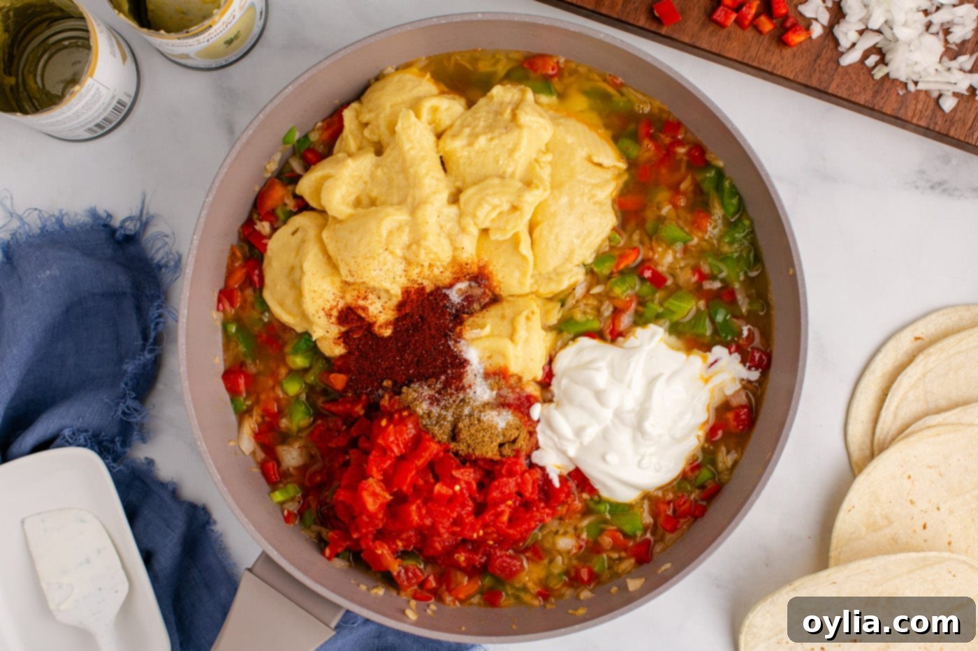 cream of chicken, seasonings, and sour cream added to sauteed veggies in a skillet