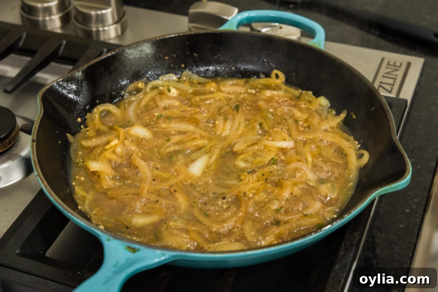 bubbling onion thyme sauce in a skillet