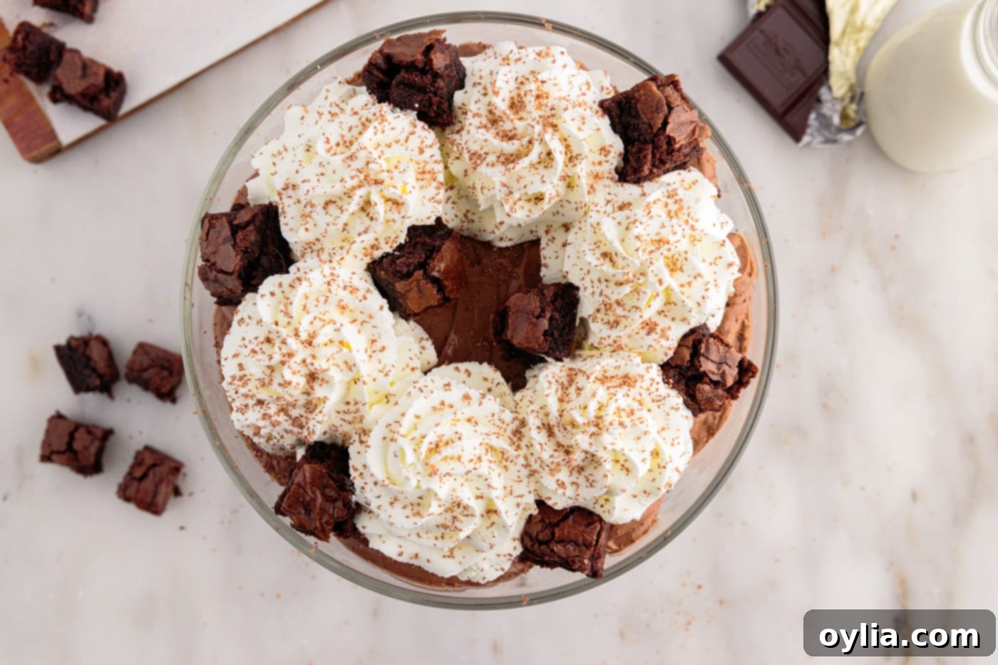 brownie pieces added to garnish of whipped cream and chocolate shavings over brownie trifle