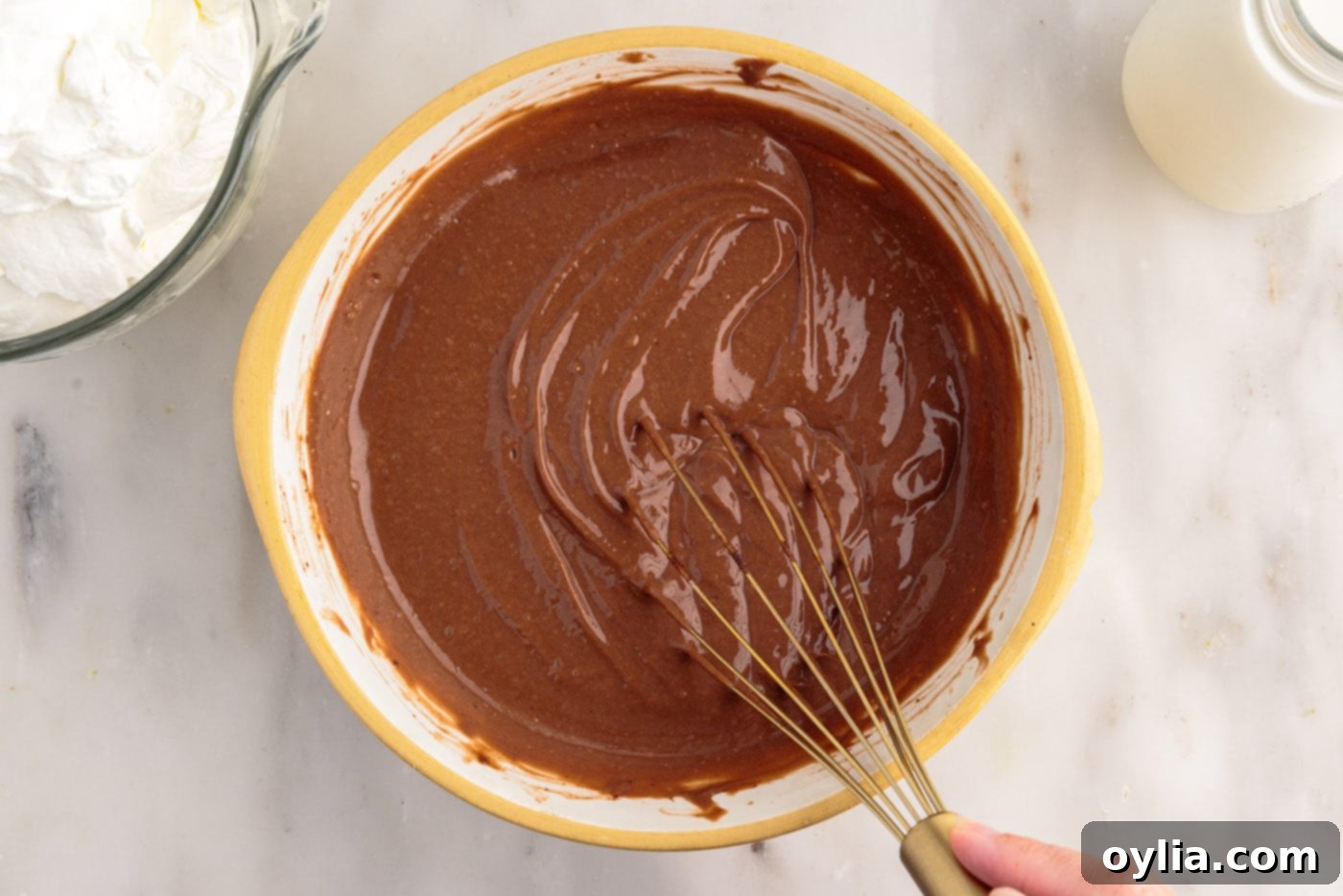 whisking instant pudding with milk in a bowl