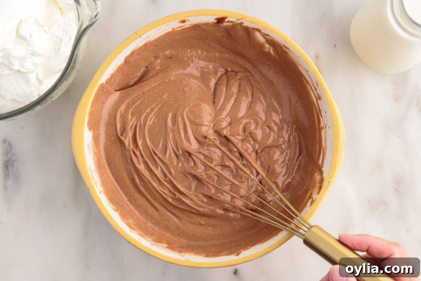 whisking whipped chocolate pudding in a bowl