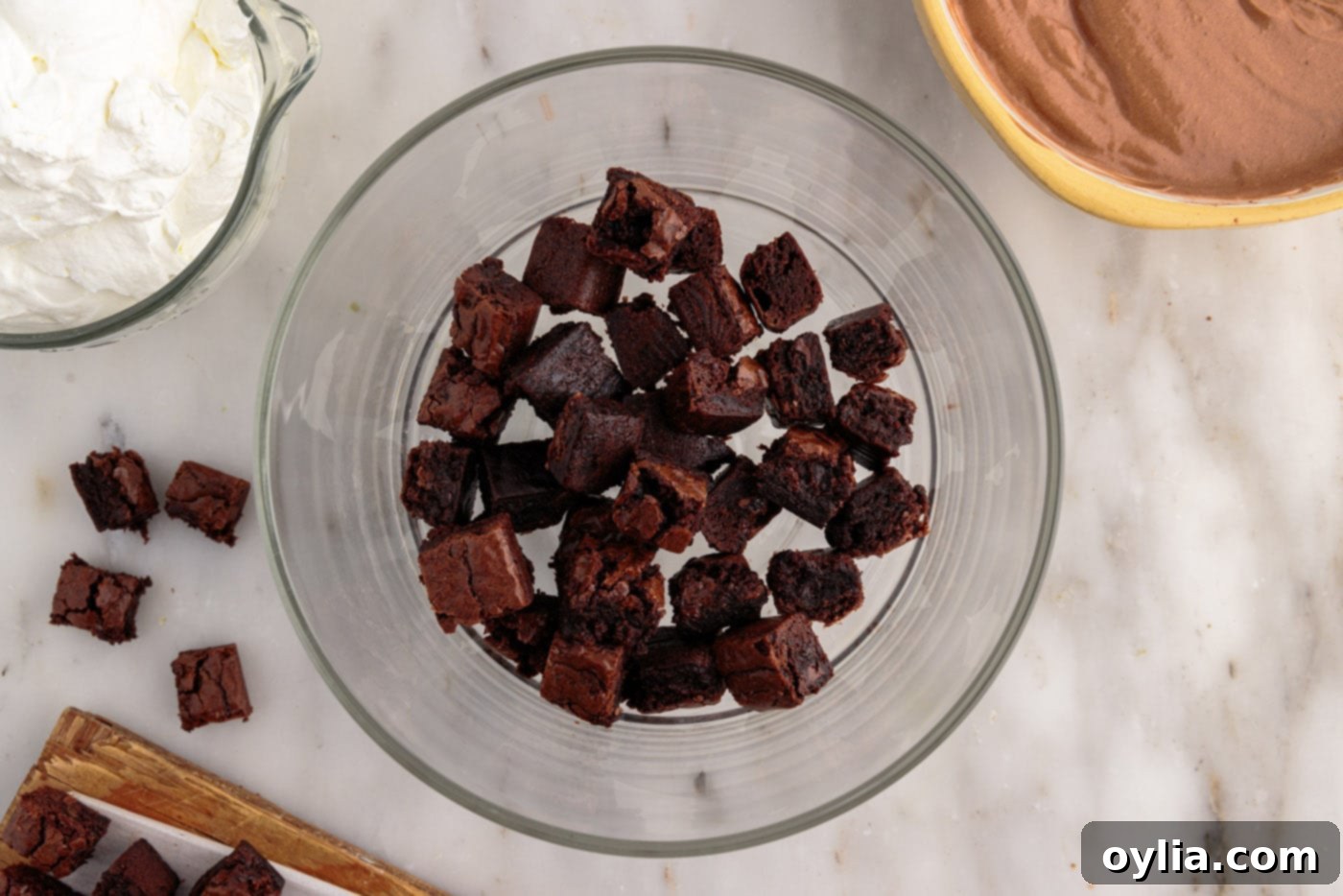 layer of brownie chunks in a trifle bowl