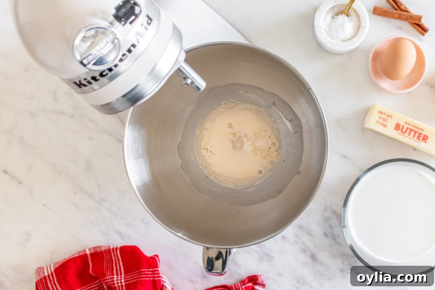 yeast, water, and sugar in a stand mixer bowl after proofing