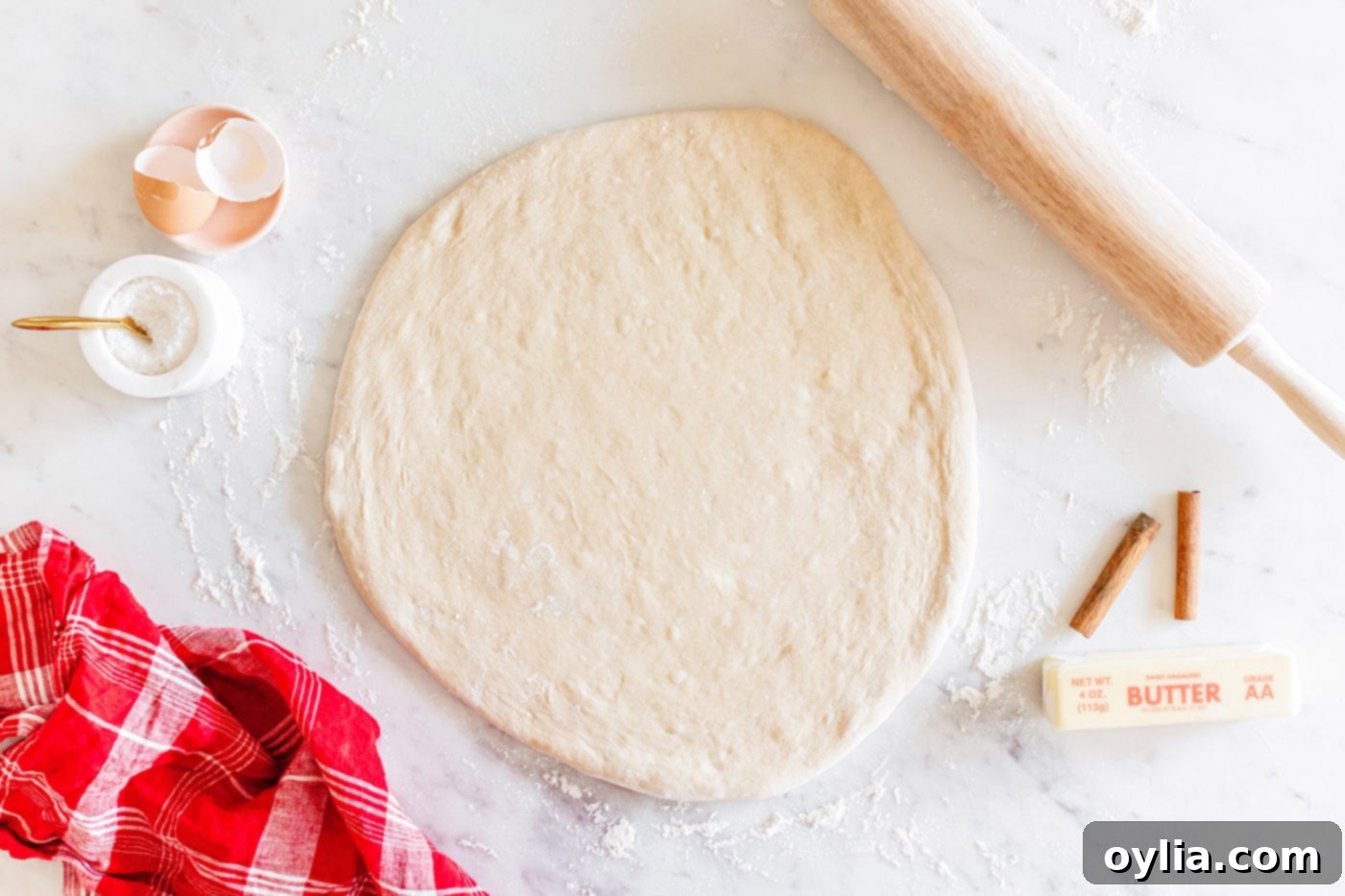 dough rolled flat on a surface for cutting
