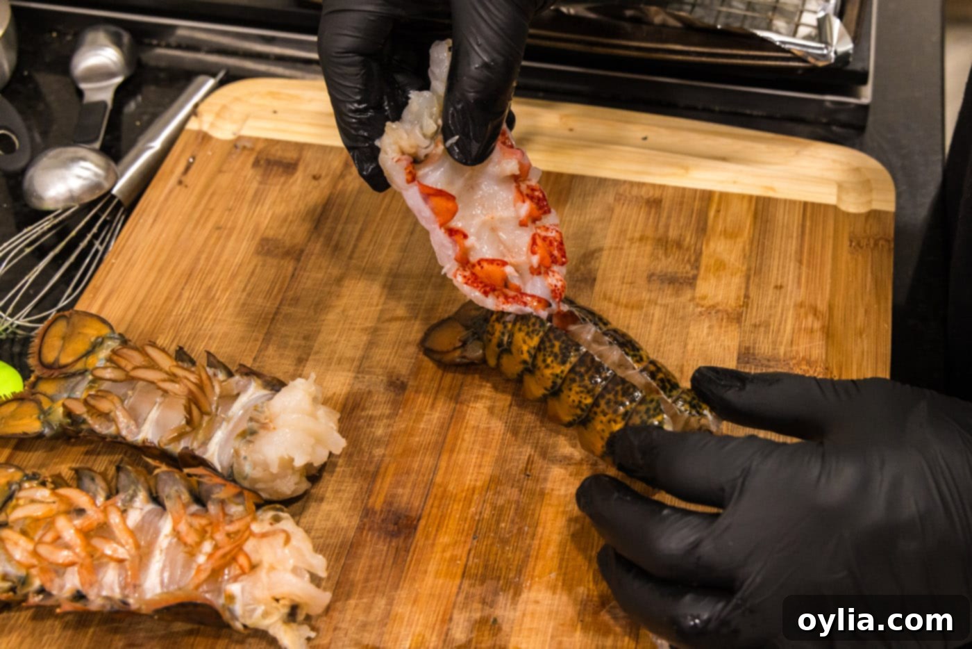 hand pulling lobster meat out of shell