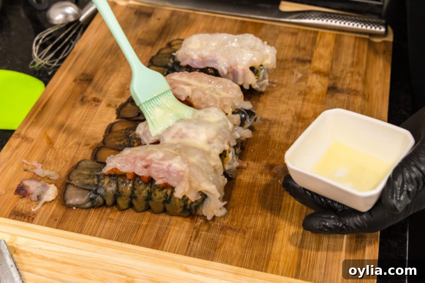 brushing crowned lobsters with melted butter
