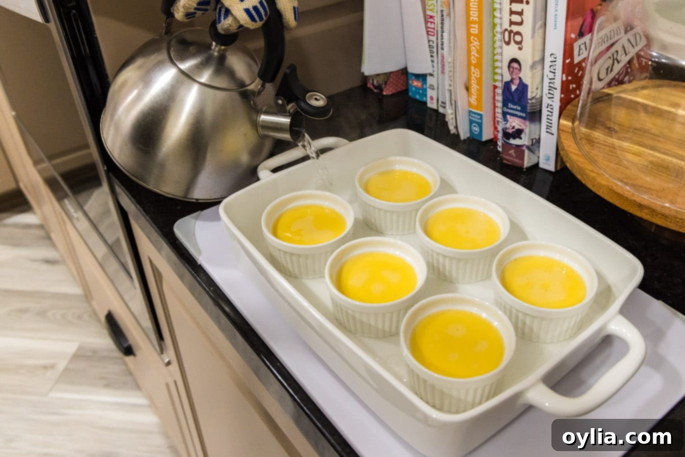 pouring water into baking dish with creme brulee
