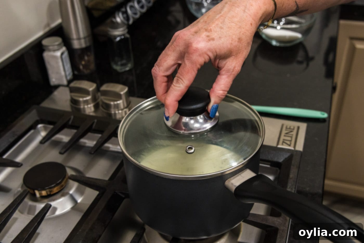 placing lid on saucepan
