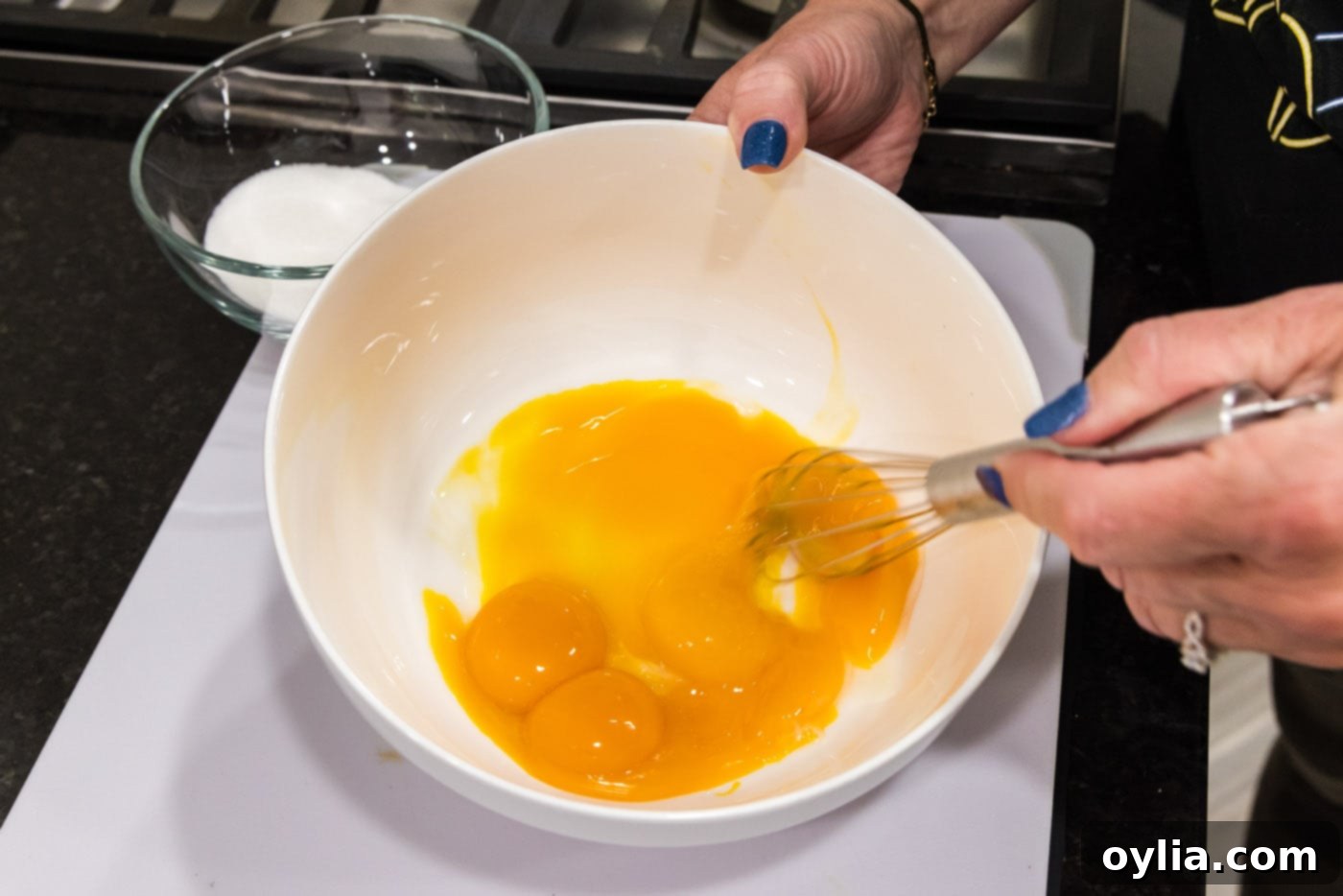 whisking egg yolks in a bowl