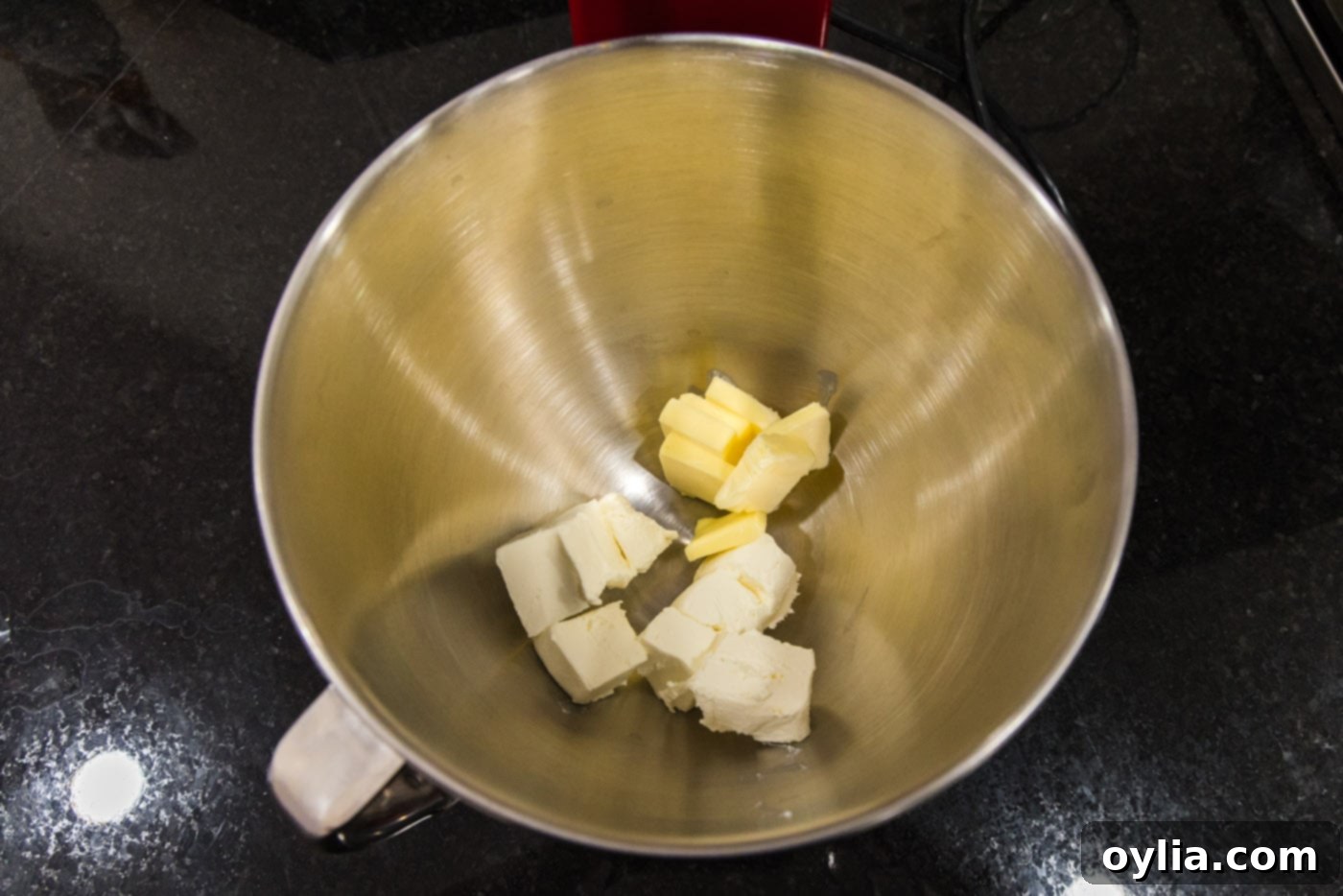 butter and cream cheese in a bowl of a stand mixer
