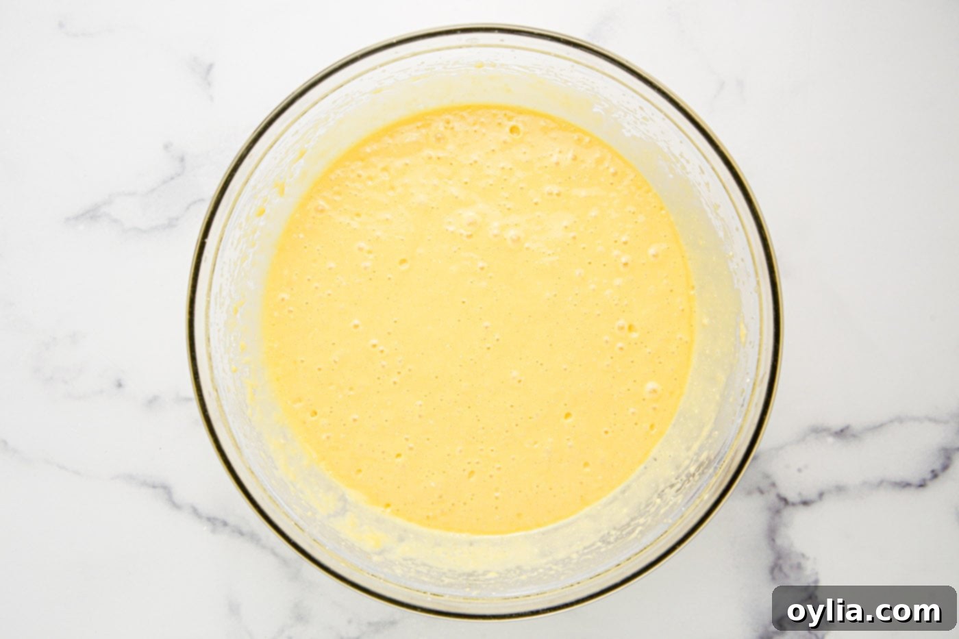 Preparing yellow cake mix for monster cupcakes.