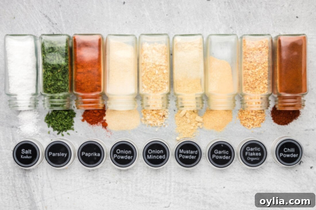 A selection of individual spice jars laid out, showcasing the ingredients for All Purpose Seasoning