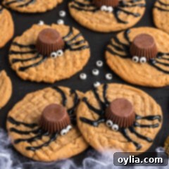 Spider Cookies on a black platter with candy eyes scattered around, a perfect Halloween party dessert.
