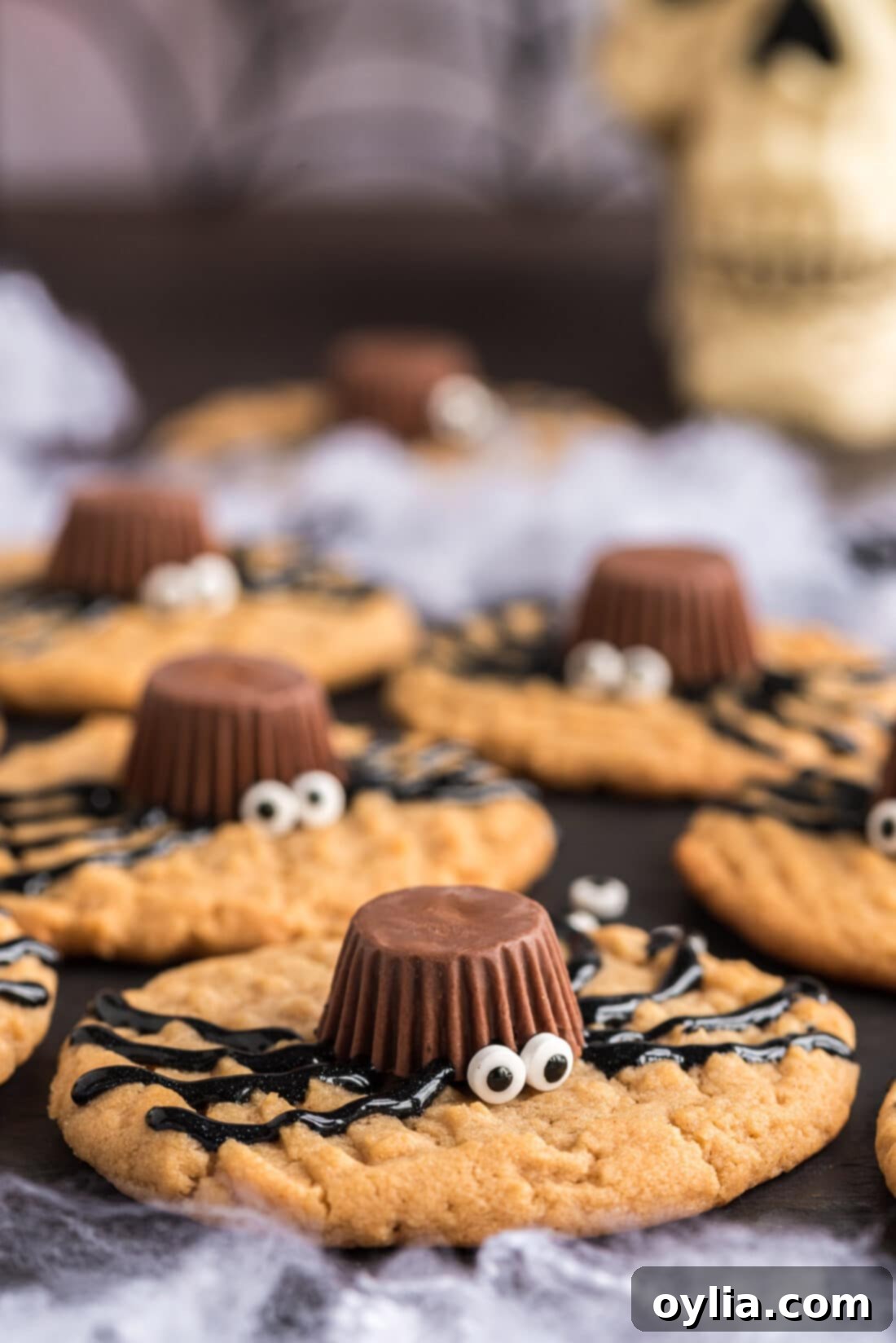 Close up photo of Halloween Spider Cookies on a platter, showcasing the detail of Reese's and candy eyes