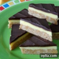 A close up photo of no bake peanut butter pudding bars resting on a green plate, ready to be served.