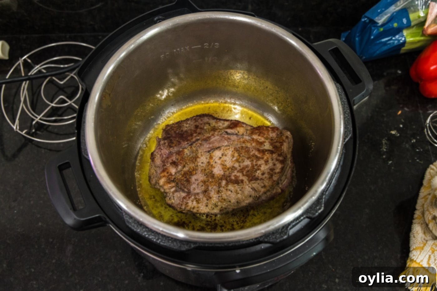 The browned roast beef removed from the Instant Pot, showing the beautifully seared exterior before pressure cooking.