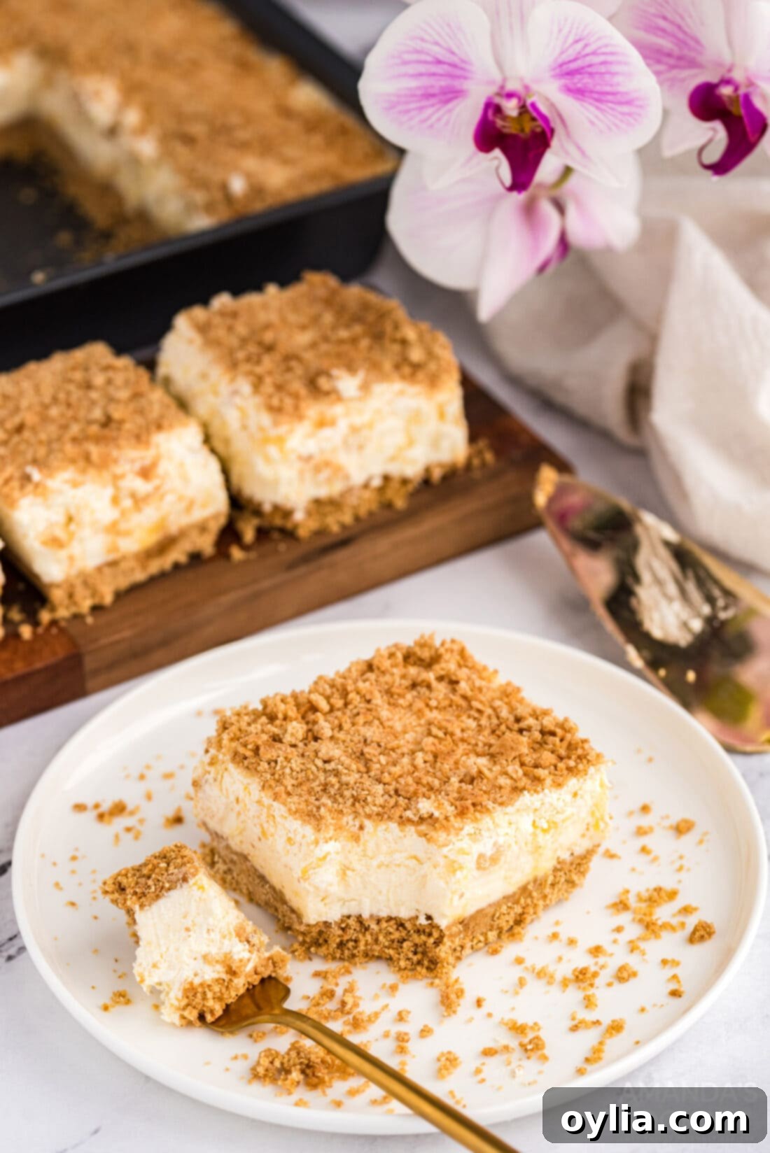 A pristine slice of Pineapple Dream Dessert served on a white plate, highlighting its elegant layers.