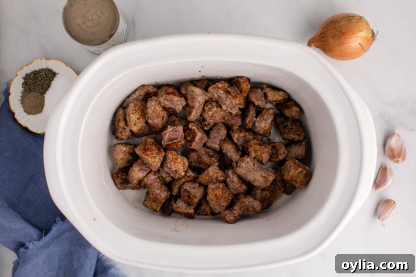 brown beef stew meat added to crockpot