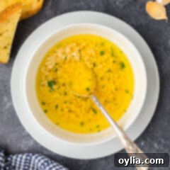 Bowl of Garlic Butter Sauce with a spoon in it