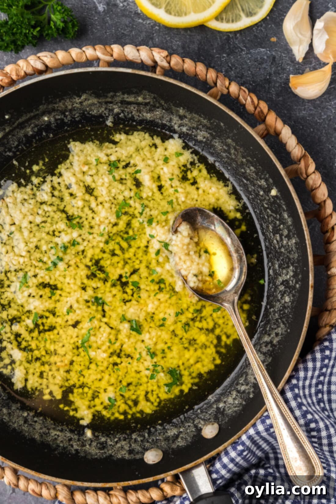 Skillet of Garlic Butter Sauce with a spoon in it