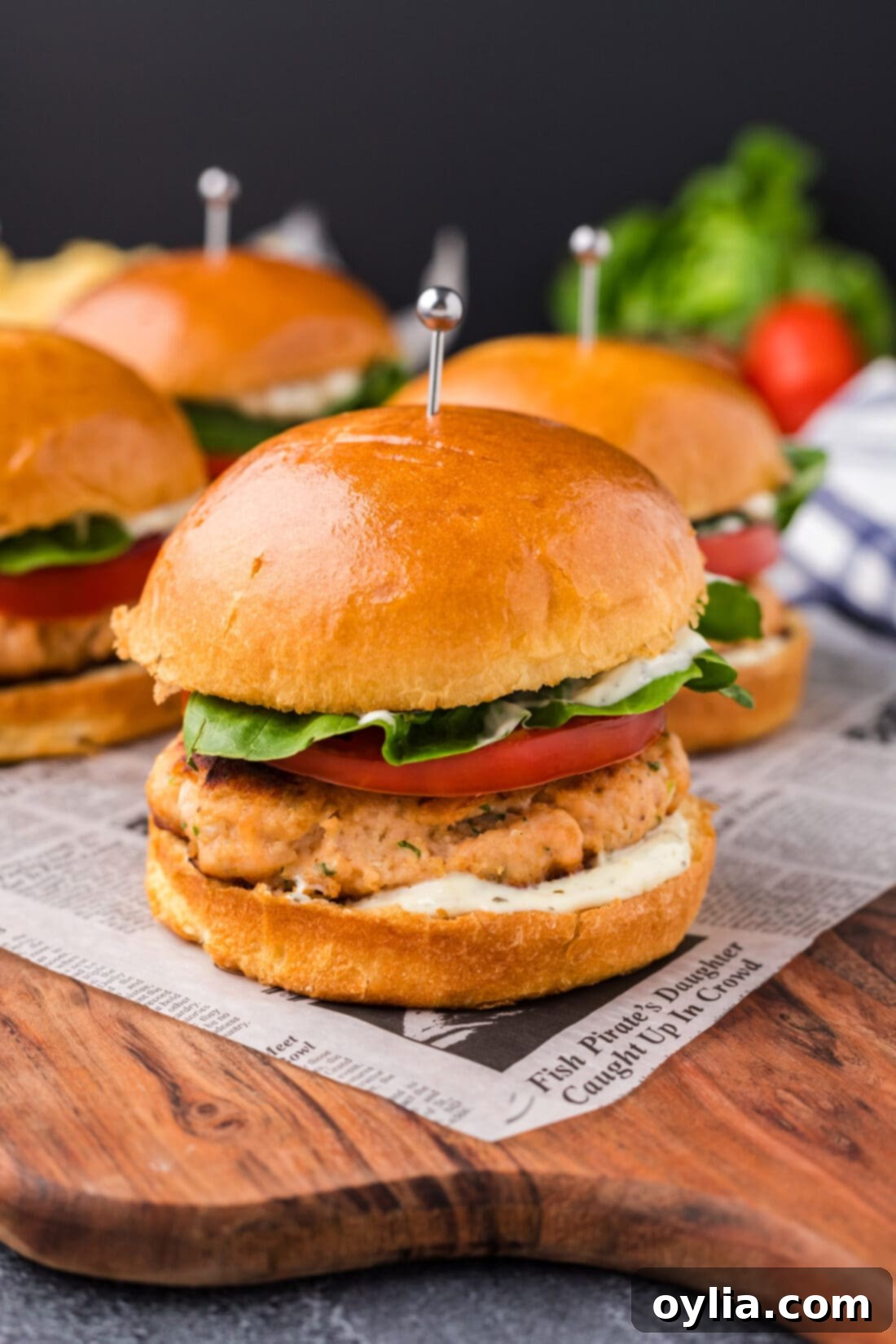 Delicious Salmon Burgers 2 Close up photo of perfectly cooked Salmon Burgers on a rustic wooden platter, ready to be served