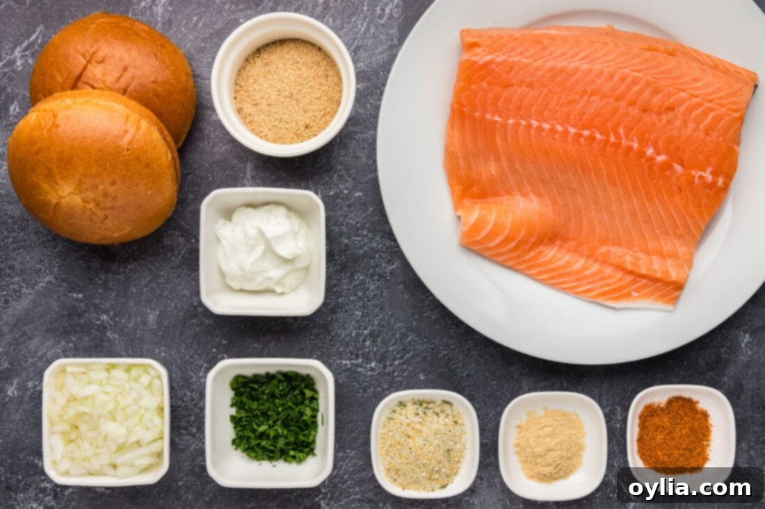 Delicious Salmon Burgers 4 A flat lay photograph showing all the fresh ingredients needed for Salmon Burgers, including salmon fillets, herbs, and spices