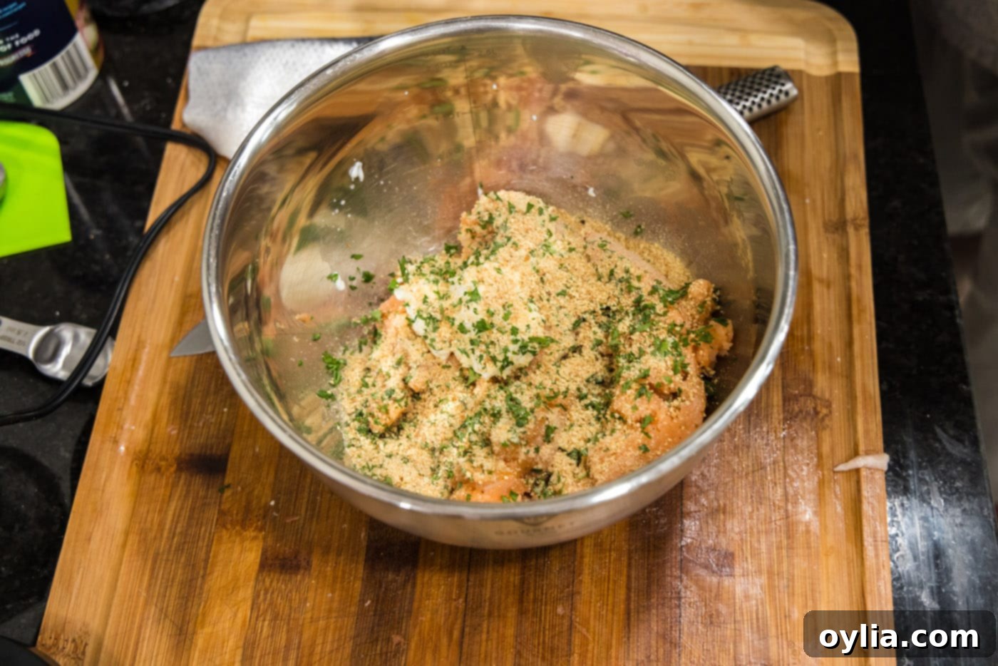Mixing parsley and breadcrumbs into the salmon and yogurt mixture