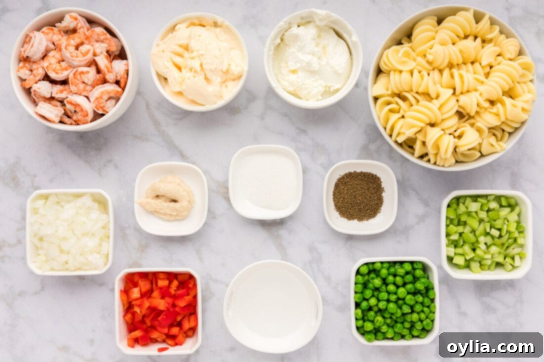 Ingredients for Shrimp Pasta Salad laid out on a cutting board