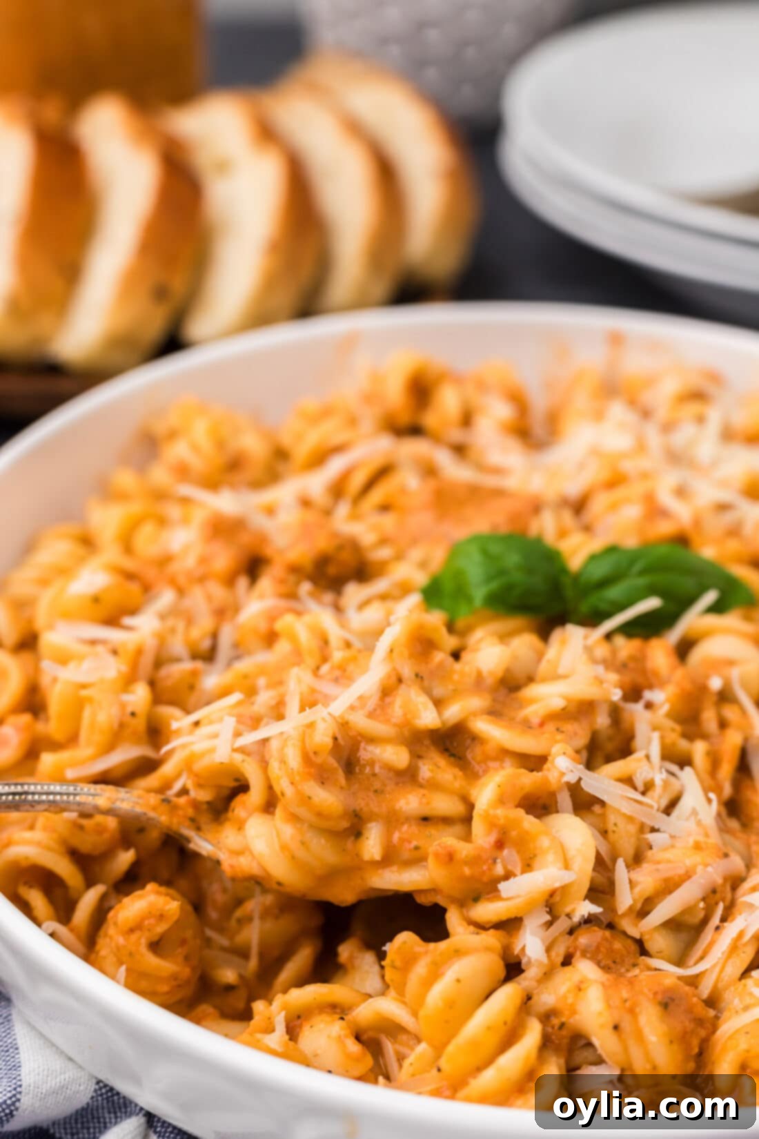 Close up photo of a spoon lifting out of a bowl of pasta covered in Vodka Sauce