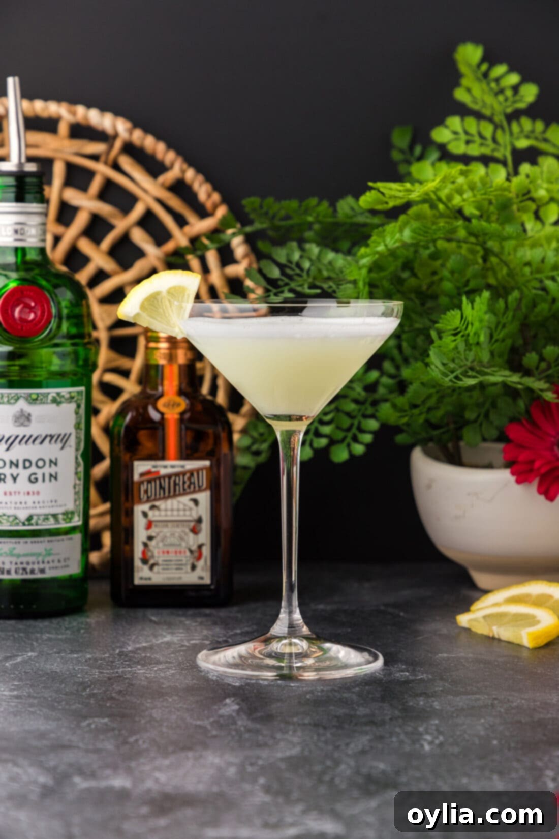Elegantly presented White Lady Cocktail with fresh lemons and ingredients in the blurred background