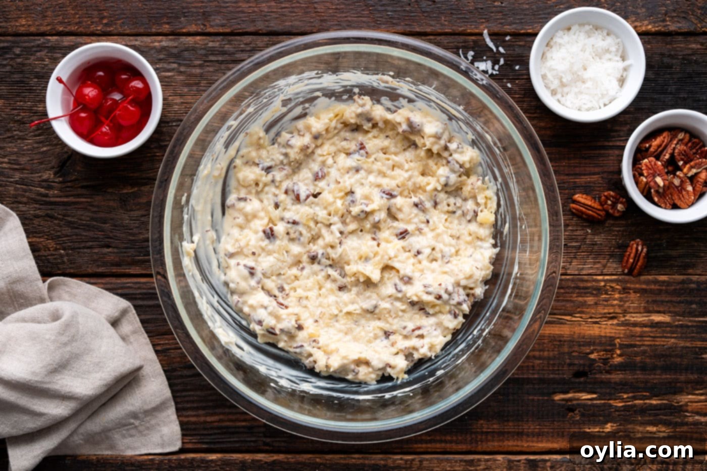 The fully mixed Million Dollar Pie filling in a bowl, showing the combined pineapple, coconut, and pecans.