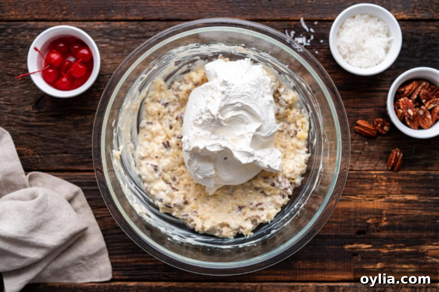 Adding Cool Whip to the pineapple, coconut, and pecan pie filling for fluffiness.