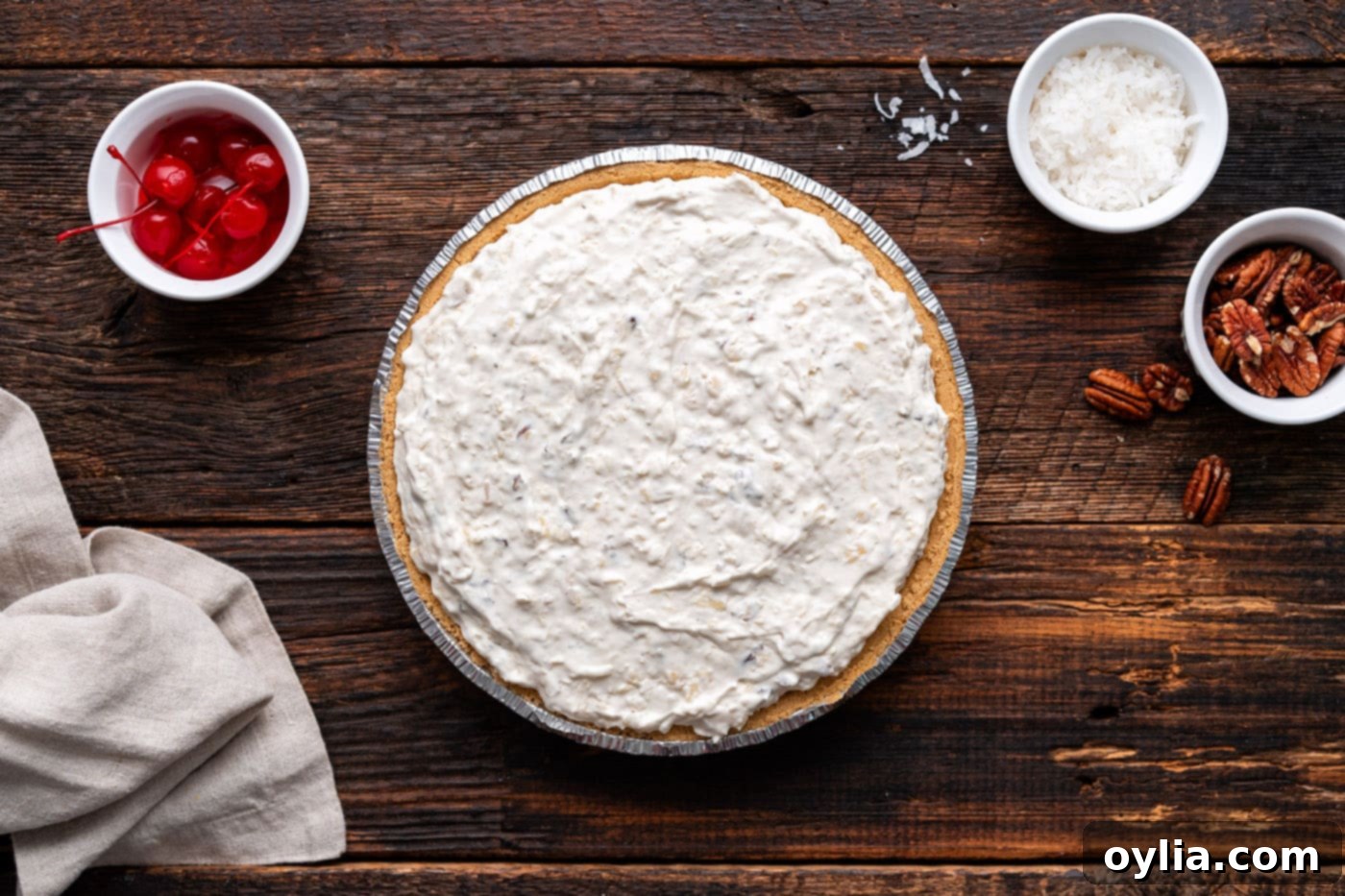 The easy Million Dollar Pie filling evenly spread in a graham cracker crust, ready for chilling.