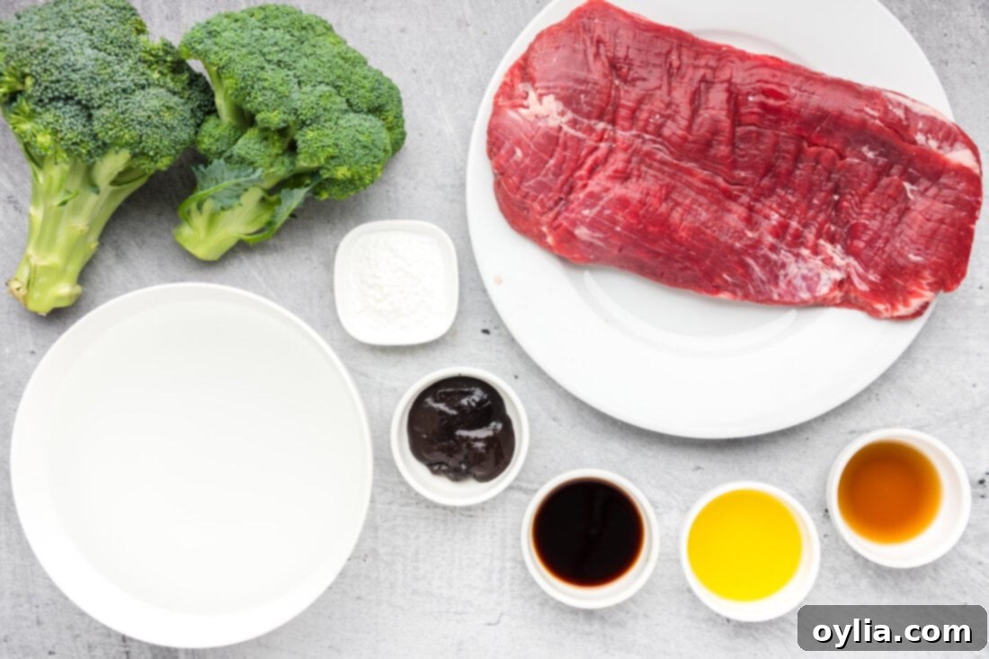 All the fresh ingredients laid out for making Instant Pot Beef and Broccoli, including flank steak, broccoli, soy sauce, garlic, and spices.
