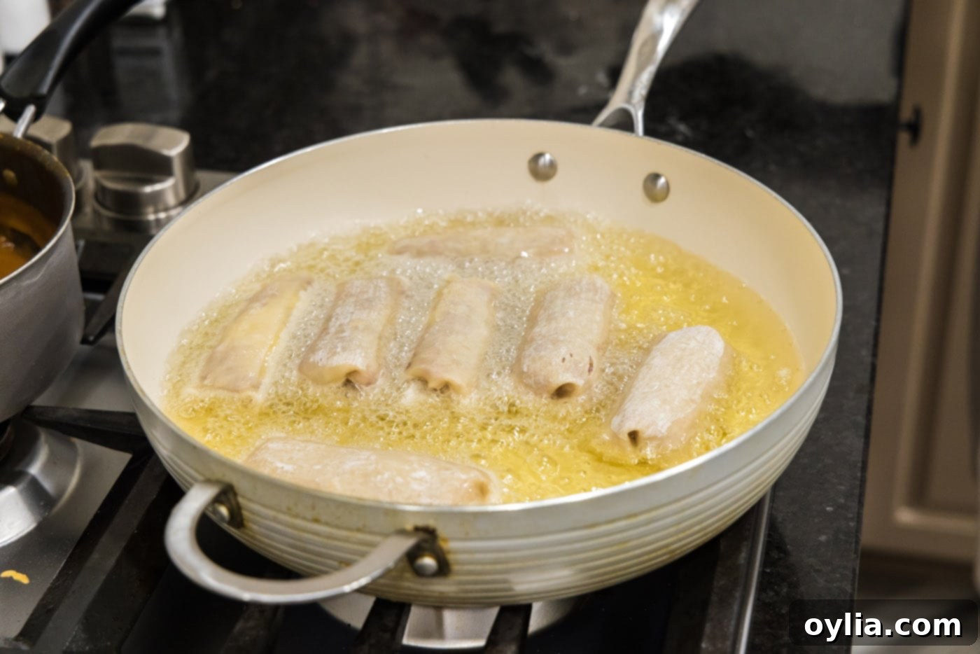 deep fried reuben egg rolls in a skillet