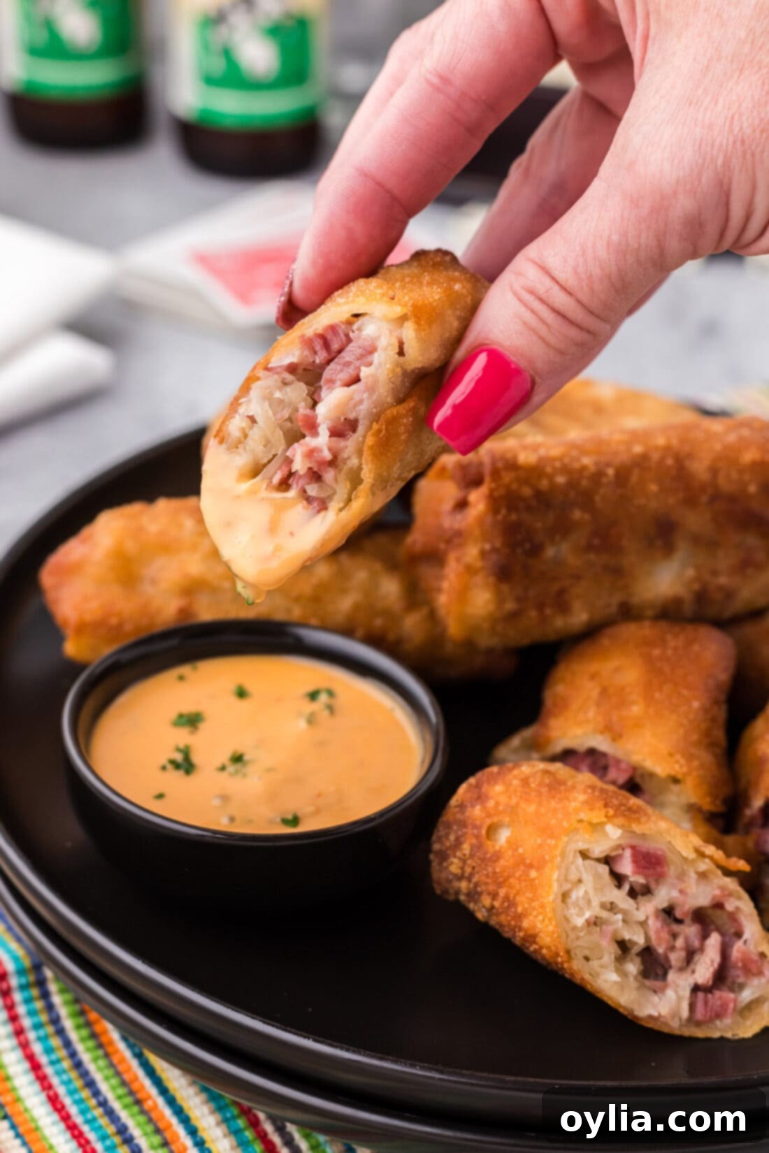 Half of a Reuben Egg Roll dipped in thousand island dressing
