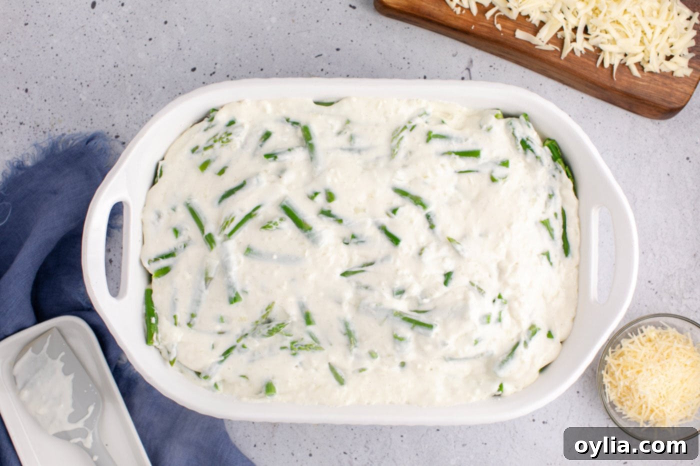 cheese sauce added to casserole dish of asparagus