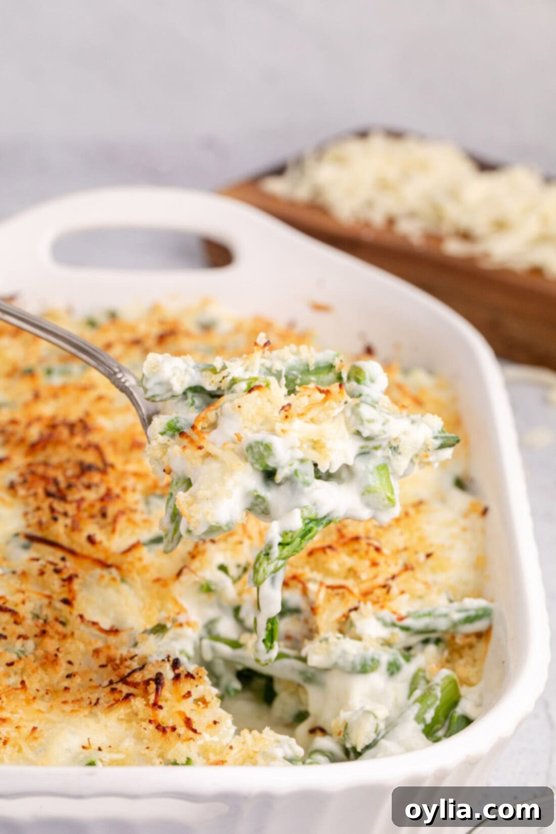 Spoonful of Asparagus Casserole being lifted out of the casserole dish