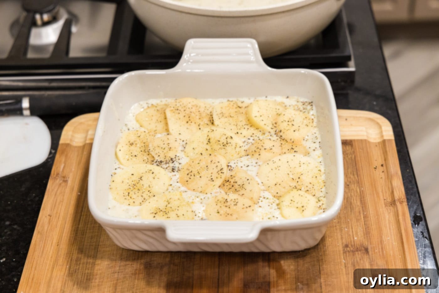 cream sauce over sliced potatoes