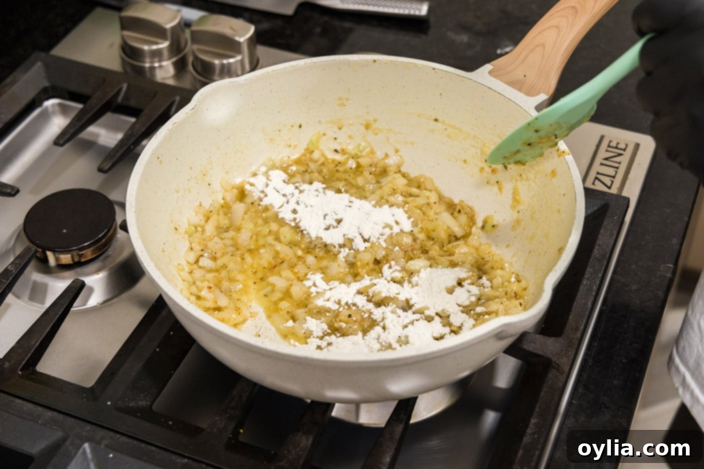 onion, garlic, and vegetable base in a skillet with flour