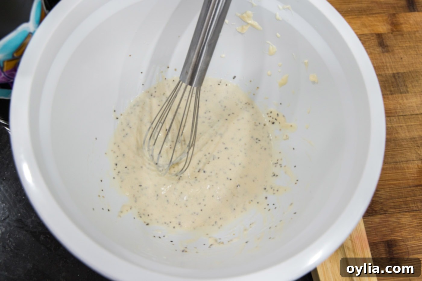 lobster salad dressing ingredients in a bowl with a whisk