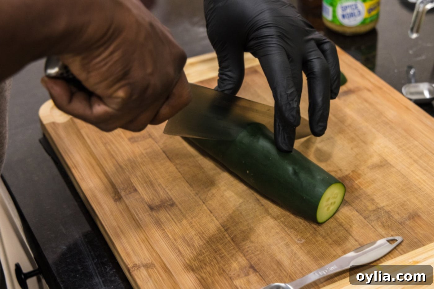 hand slicing cucumber with a knife
