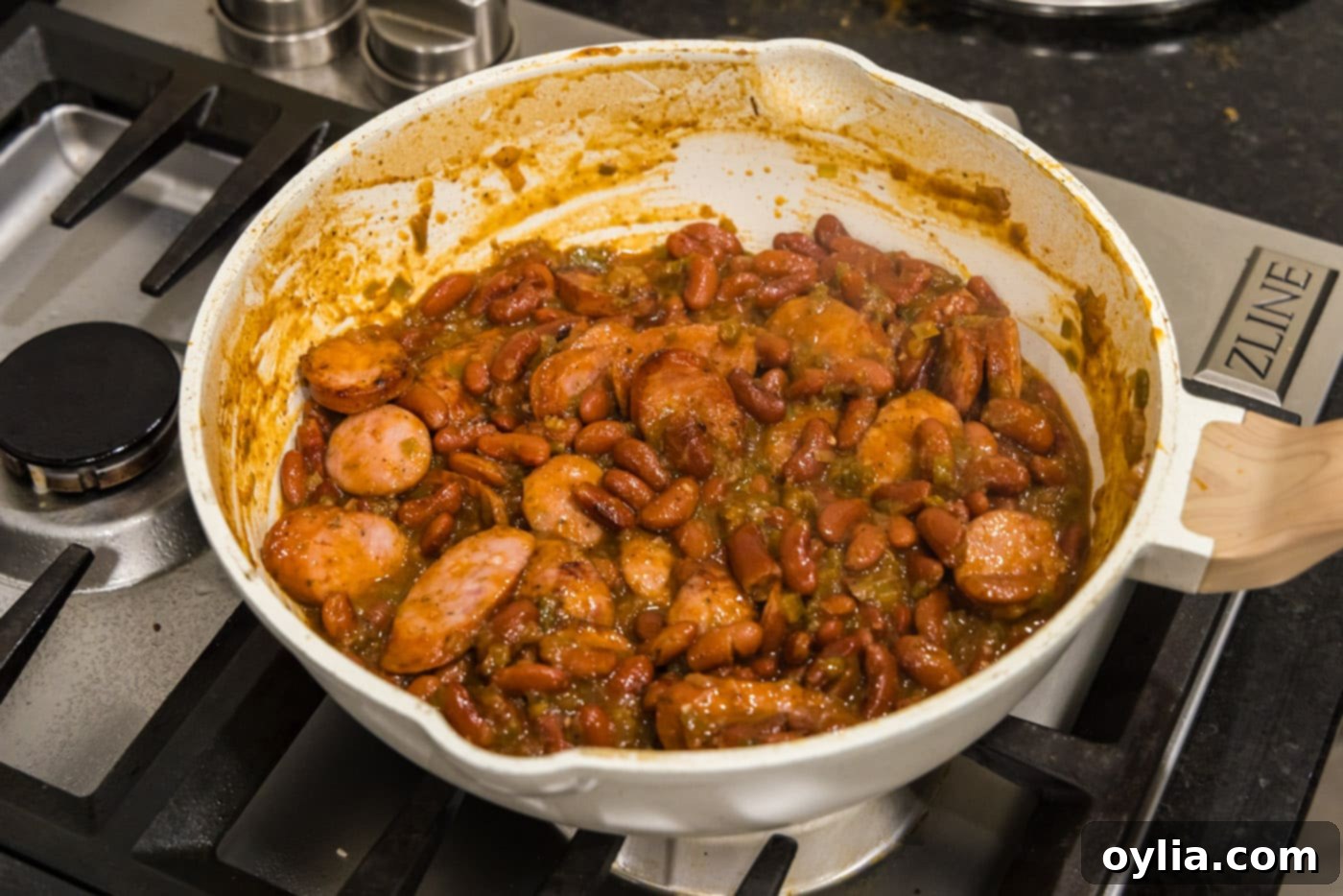 sliced andouille sausage with cajun red beans in a skillet