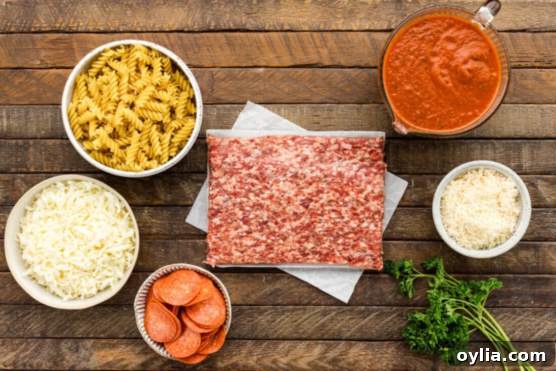 Hearty Sausage and Pepperoni Pizza Bake 4 Ingredients for Sausage & Pepperoni Pizza Casserole laid out on a kitchen counter