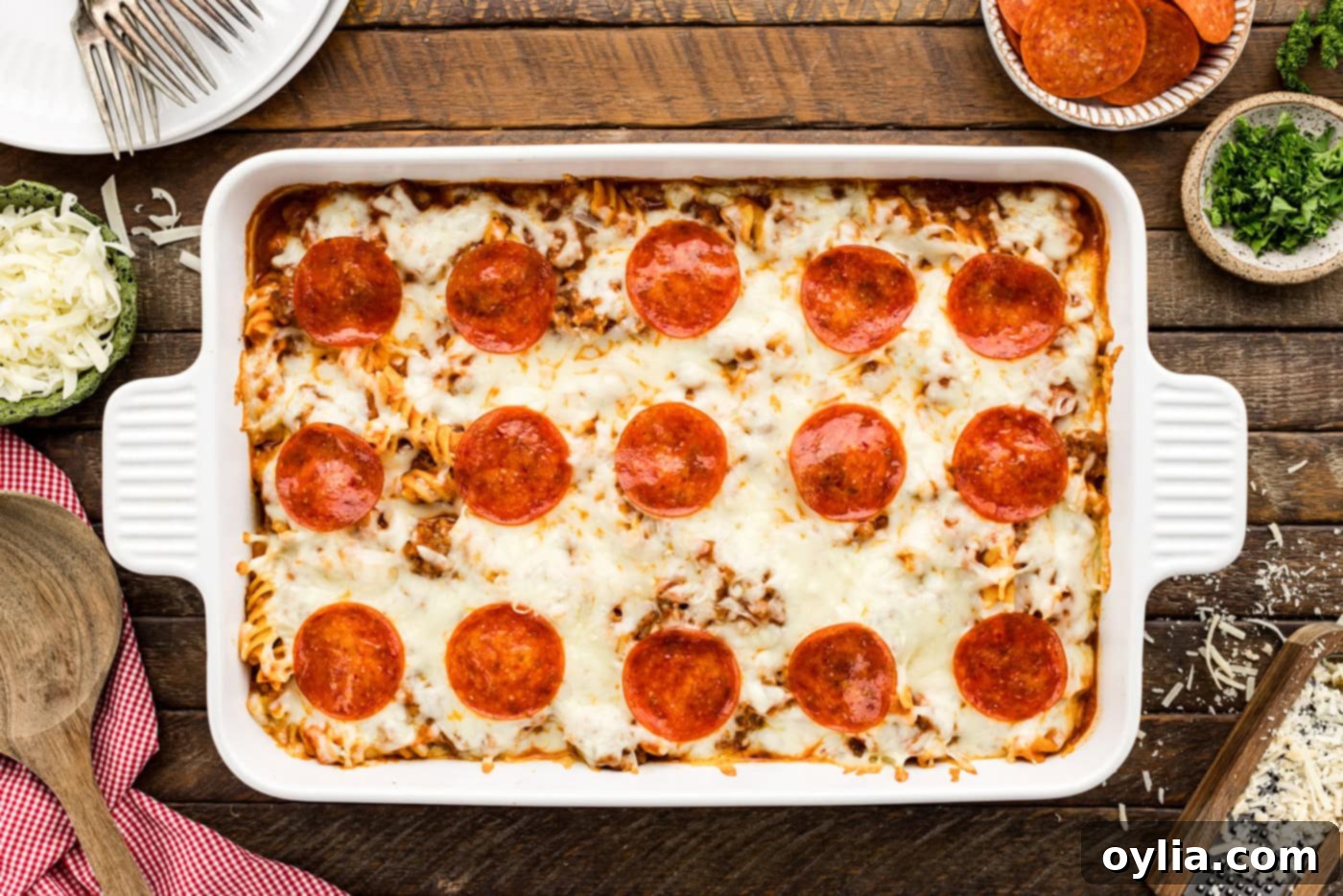 overhead shot of baked pizza casserole in a baking dish, with bubbly, golden cheese and crispy pepperoni