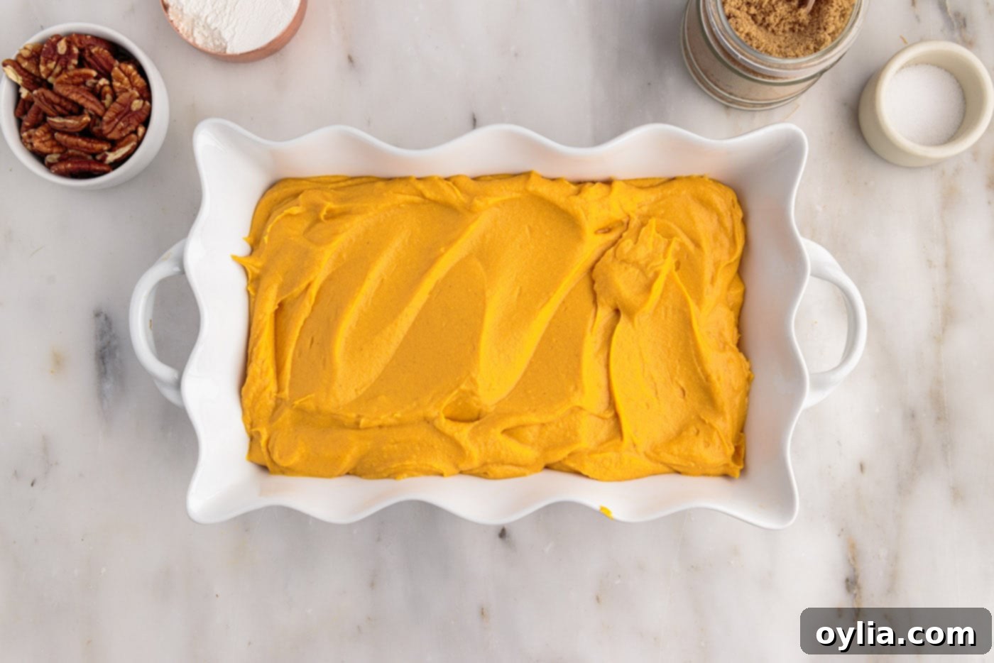 creamy sweet potato filling spread evenly in a baking dish