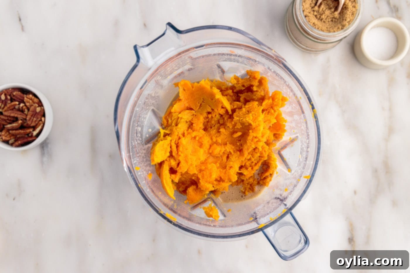 adding cooked sweet potatoes to blender with souffle ingredients