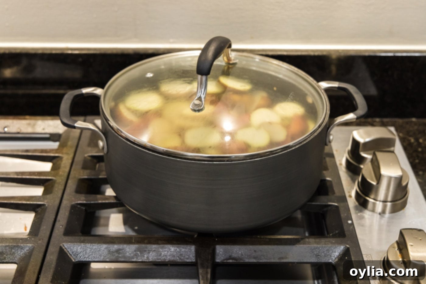 pot of red baby potatoes cooking with the lid