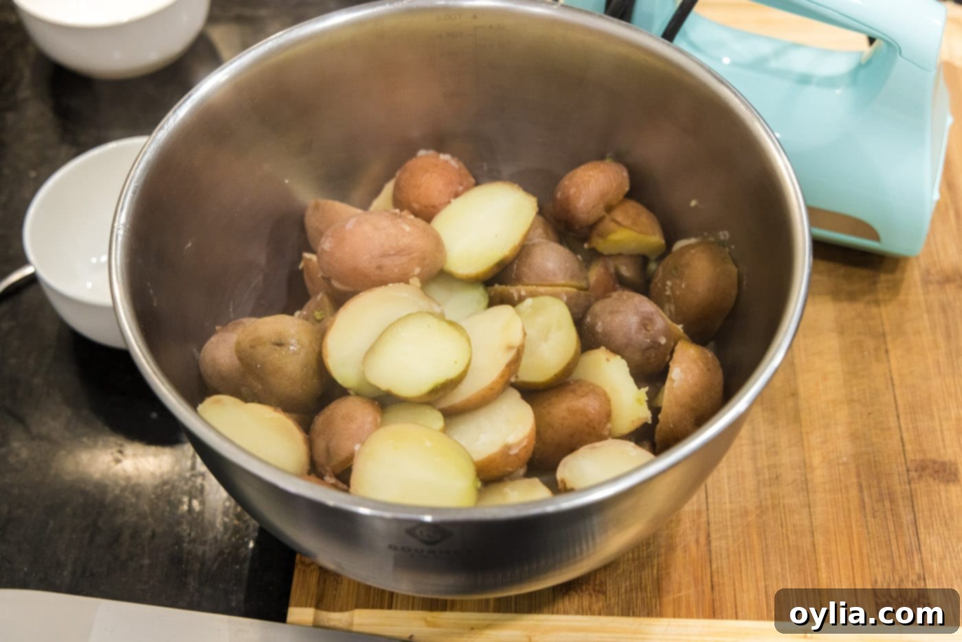 cooked sliced red potatoes in a mixing bowl
